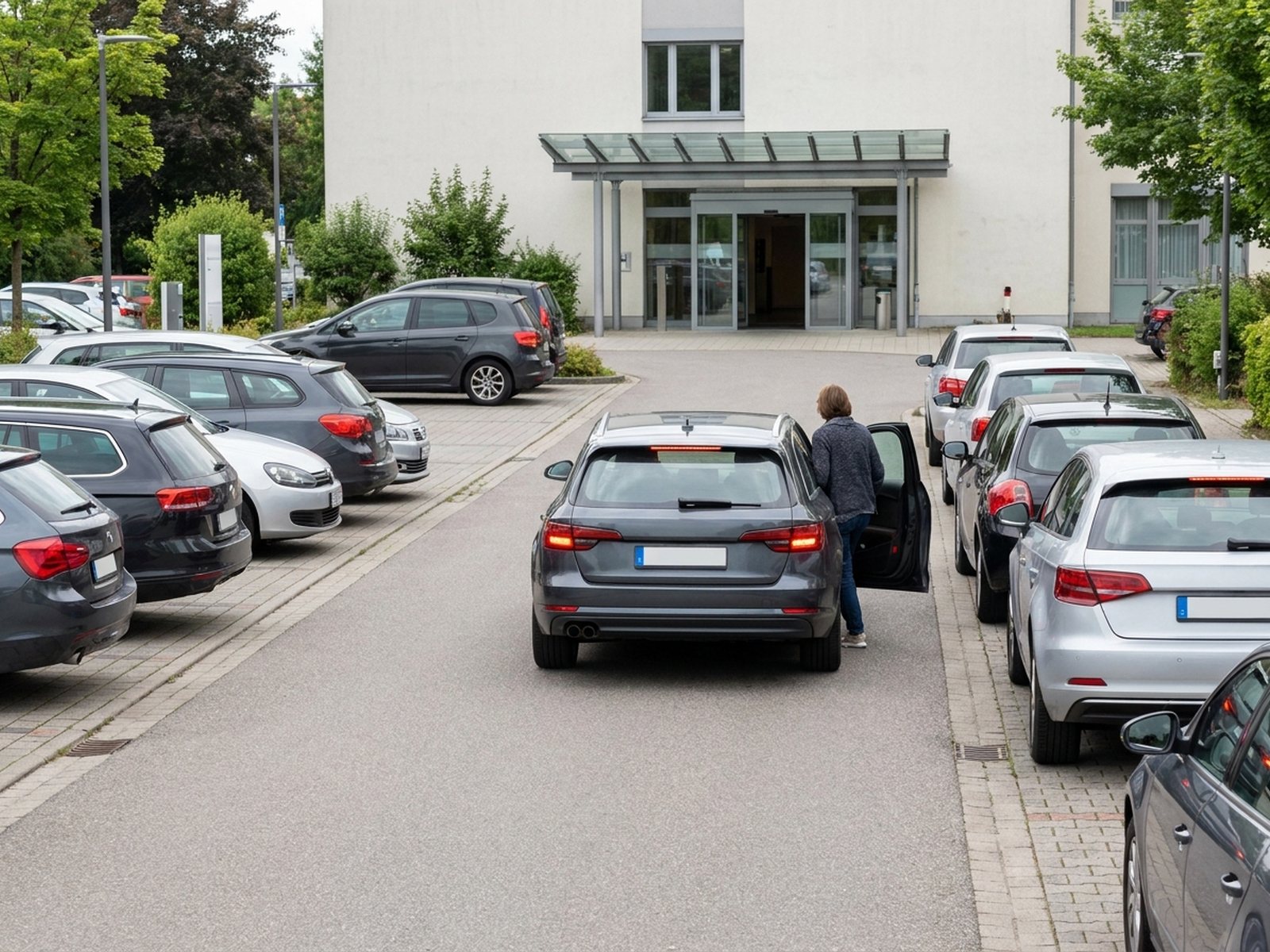 Vorfahrt einer Klinik, die Haltebuchten sind belegt, ein Auto hält in zweiter Reihe